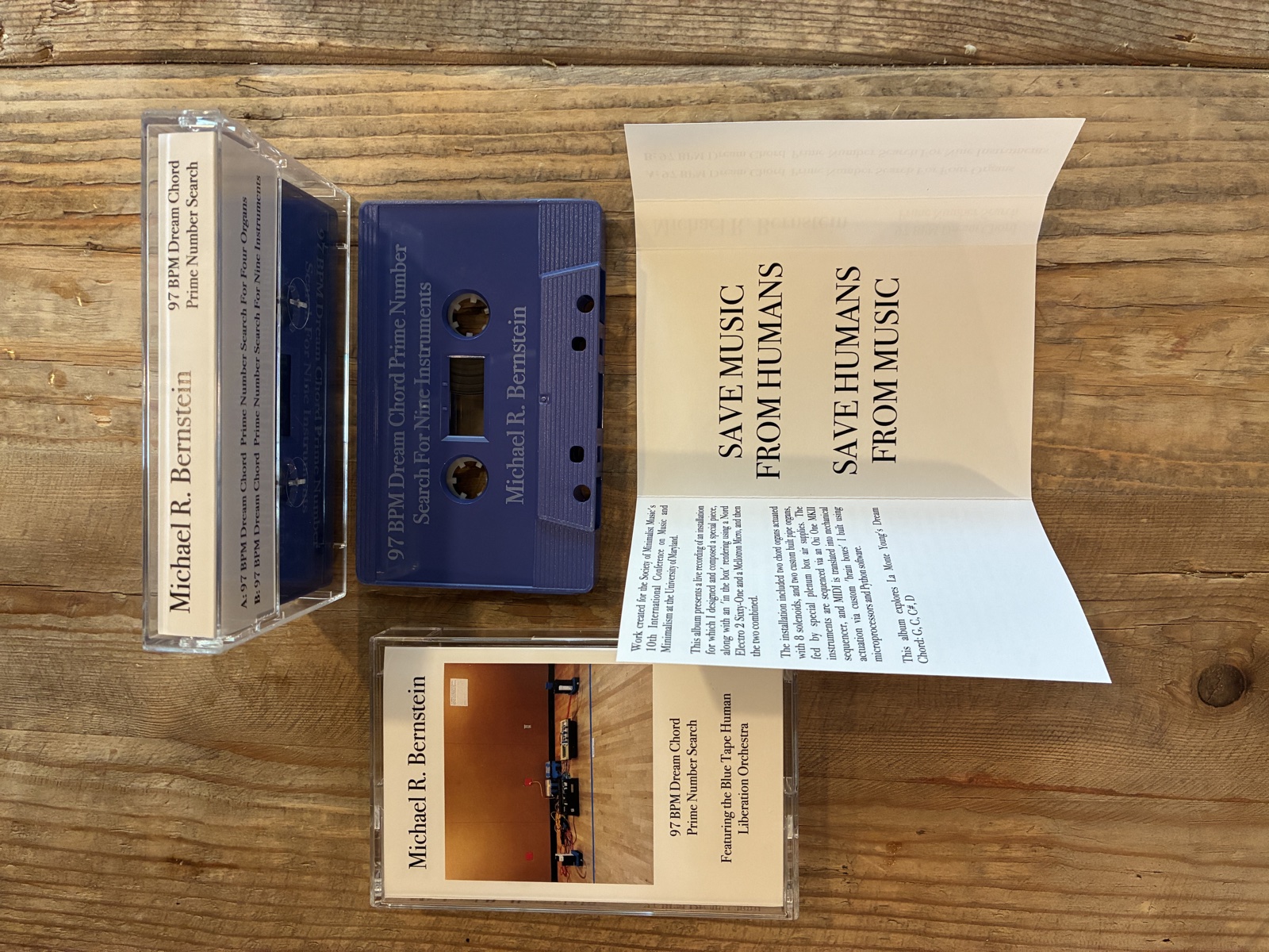 Cassette packaging: case with spine and j-card, blue cassette, and unfolded insert reading Save Music From Humans / Save Humans From Music
